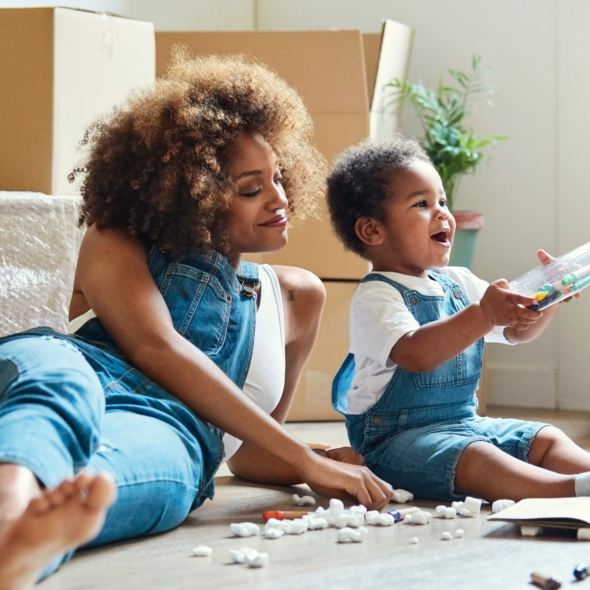 Mom with her baby surrounded with moving boxes