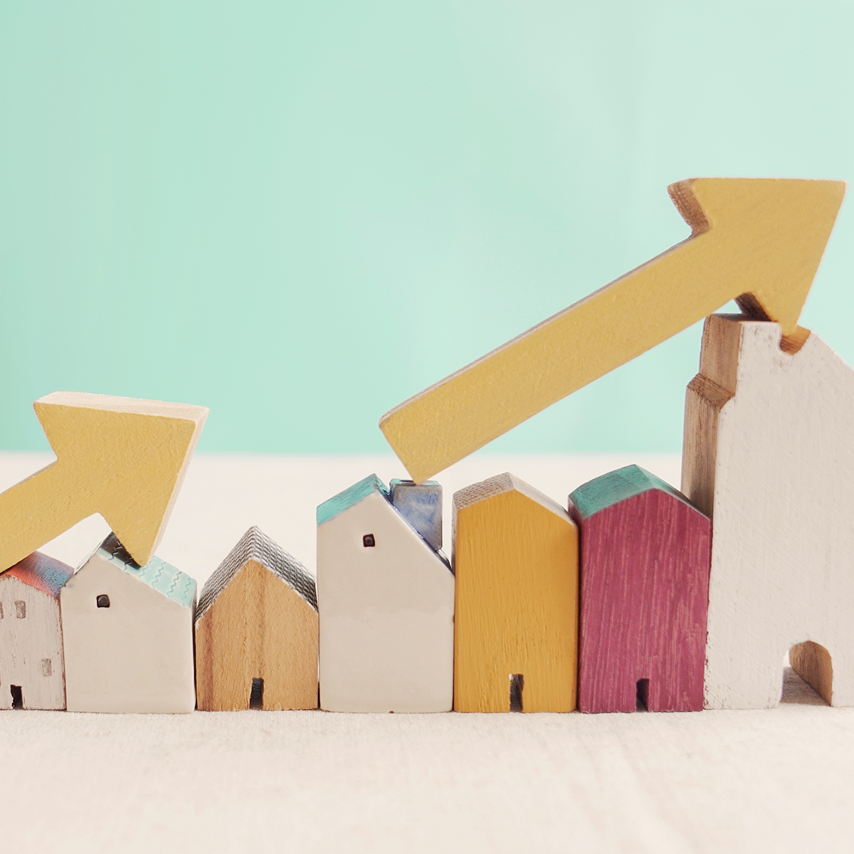 wooden houses with rising arrows